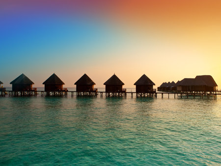 Island in ocean, overwater villas at the time sunset.のeditorial素材