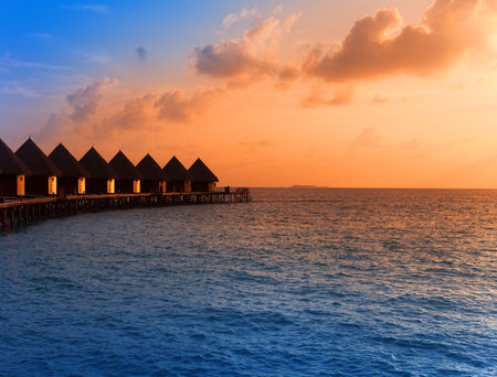 Island in ocean, overwater villas at the time sunset.のeditorial素材