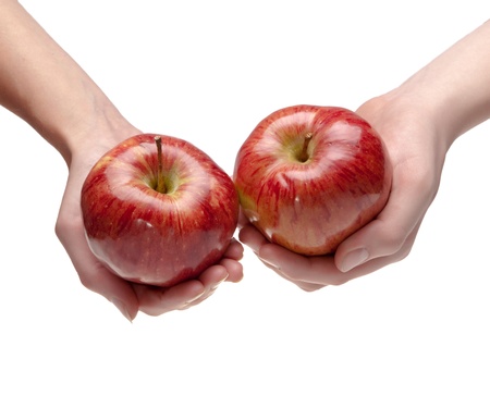 Two hands give each other an appleの写真素材