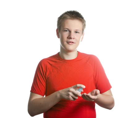 The boy, the teenager spraying fragrance perfumeの写真素材