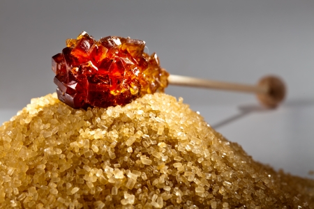 candy sugar on a stick on a heap of granulated sugar

の写真素材