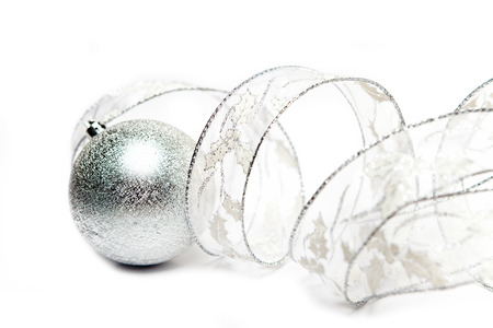 Beautiful silvery New Year's ball and decorative tape on a white background

の写真素材