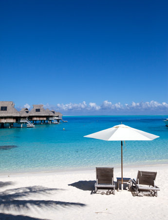 Umbrella and chaise lounges on a beach.のeditorial素材