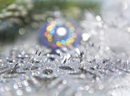 Decorative New Year's background - tinsel and a ball out of focusの写真素材