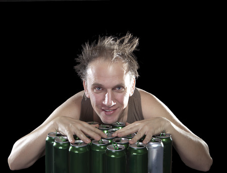 The happy tipsy man near empty beer jarsの写真素材