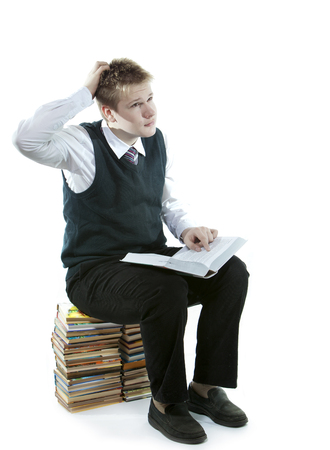 The teenager with a heap of textbooks.の写真素材