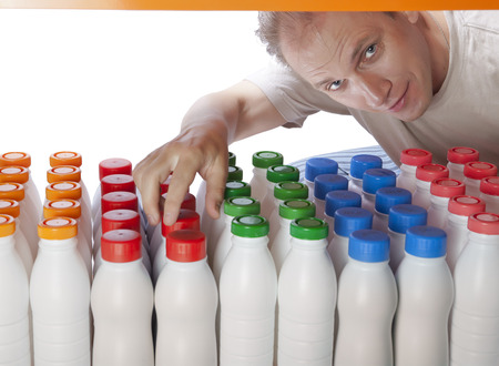 The man selects dairy products in the shopの写真素材