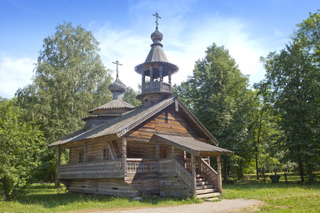 Ancient wooden church on a forest glade. Russia.の写真素材