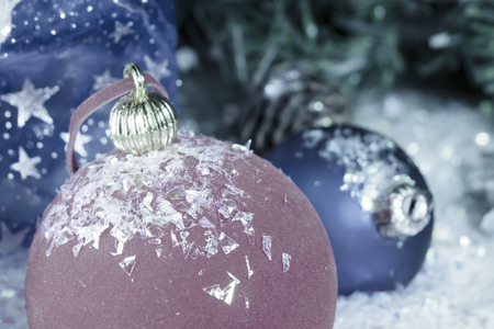 red and blue New Year's ball on decorative snow and a bag with gift, toningの写真素材