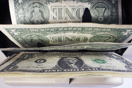 electronic money counter machine is counting is counting the American one dollar(US dollars) banknotesの写真素材