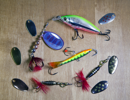 Fishing tackle, Different spinners for a bait of fish on wooden backgroundの写真素材