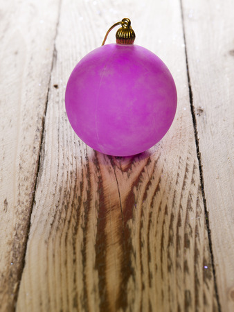 Christmas and New Year Concept 2018. Pink New Year's ball on a wooden board

の写真素材