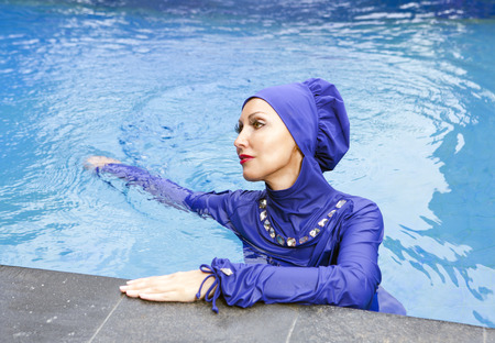 attractive woman in a Muslim swimwear  burkini in the poolの写真素材