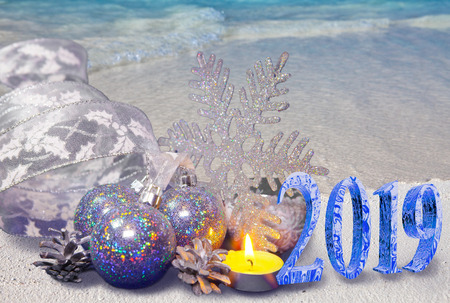 Christmas composition on the sandy seashore and the inscription 2019- New Year card