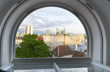 Tallinn. View from the roof window on the roofs of the old town and modern houses in the distanceの写真素材