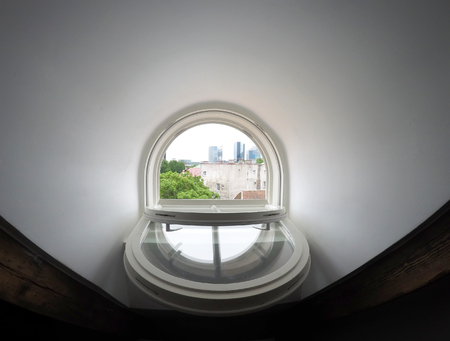 Tallinn. View from the roof window on the roofs of the old town and modern houses in the distanceの写真素材