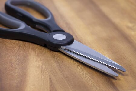 Kitchen, culinary scissors on a wooden tableの写真素材