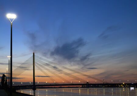 Riga, Latvia. Vansu suspension bridge over the Daugava River in the eveningの写真素材