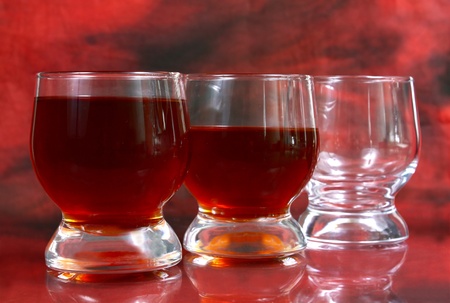 alcohol drink is in a glass on red backgroundの写真素材