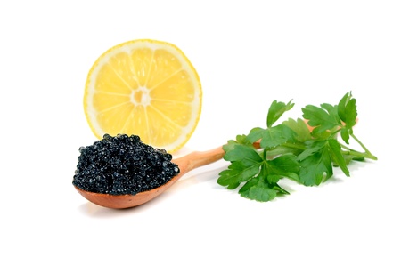 caviar black is in a wooden spoon isolated on white backgroundの写真素材