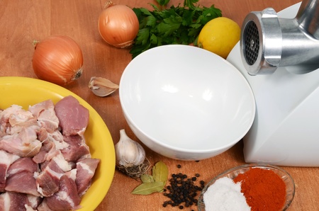 raw meat with spices and meat grinder for preparation of stuffingの写真素材