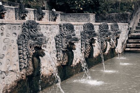 Stone statues spewing sulfuric water in Banjar Hot Springs (Singaraja, Indonesia).の写真素材