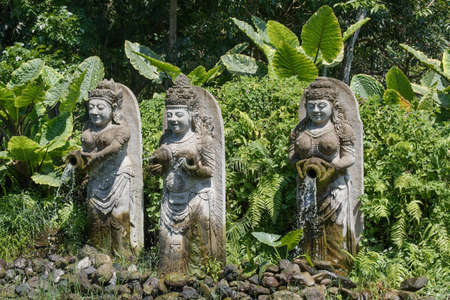 Statues standing in front of the Monkey forest in the city of Ubud on the island of Bali.