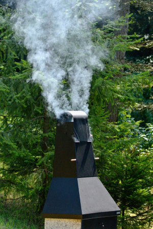 Smokehouse from which white smoke comes out.の写真素材