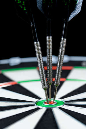 Darts stuck in the center of the target.