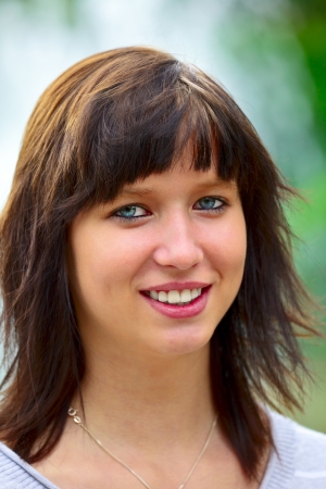 Portrait of a young woman in background blue water, outdoor in city park in a small city Dillingen,  Saarland   Germanyの写真素材