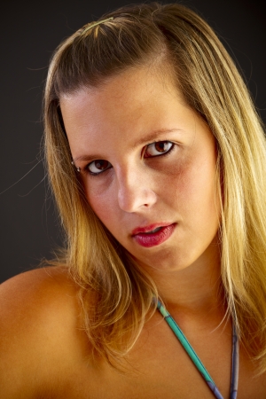 Young blond woman on black backgroundの写真素材