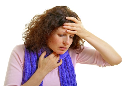 Young woman with brown hair has a flu and headache, isolated on white backgroundの写真素材