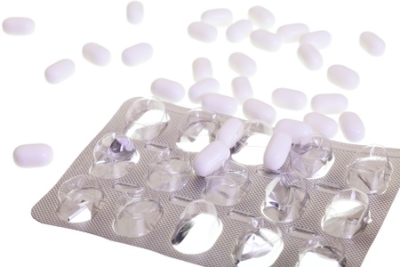 Close up of a empty pill blister and white pills isolated on white background.  
の写真素材