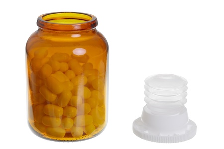 A  pill jar and white pills isolated on white background, studio shoot.の写真素材