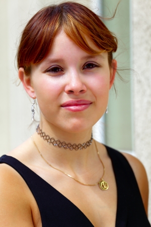 Portrait of a young woman in the background a white  wall,  in small city Saarlouis, Saarland / Germanyの写真素材