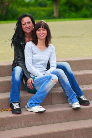Portrait of a mother and daughter in background the steps in the park in city Dillingen, outdoor  in a small city Dillingen,  Saarland / Germanyの写真素材