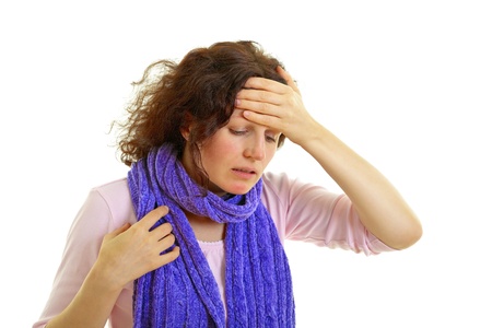 Young brown-haired woman with wool scarf has headache, isolated on white background, studio shot.の写真素材