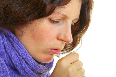 Young woman with brown hair has a flu, isolated on white background, studio shot. の写真素材