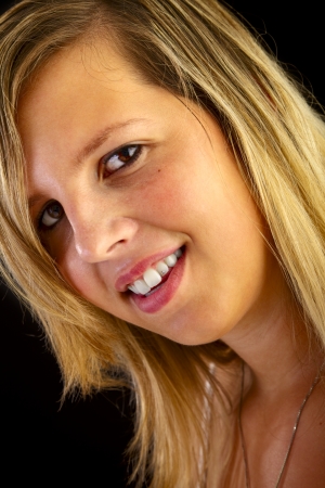 Young blond woman on black backgroundの写真素材