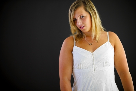 Young blond woman on black backgroundの写真素材