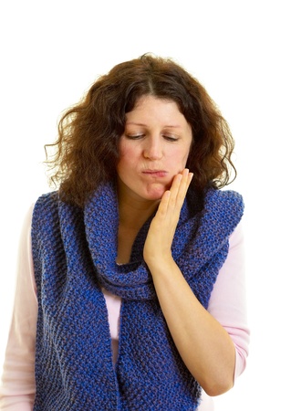 Young brown-haired woman with wool scarf has toothache, isolated on white background, studio shot. Adobe RGBの写真素材