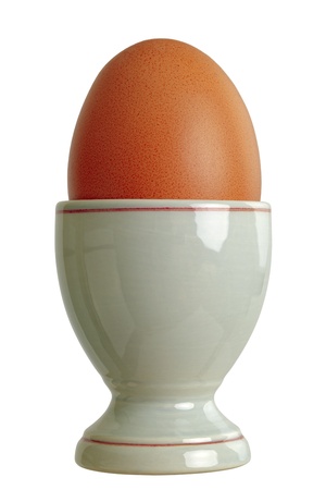 Closeup of a eggcup with chicken egg, isolated on white backgroundの写真素材