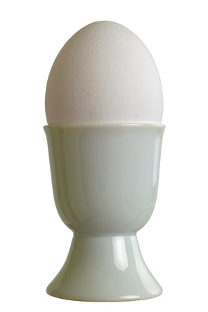 Closeup of a eggcup with chicken egg, isolated on white backgroundの写真素材
