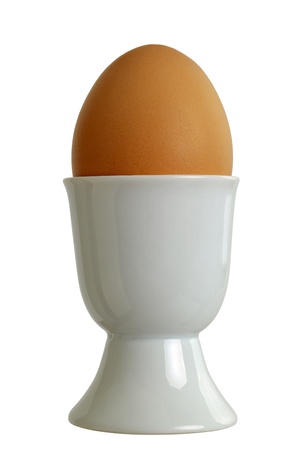 Closeup of a eggcup with chicken egg, isolated on white backgroundの写真素材