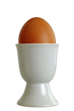 Closeup of a eggcup with chicken egg, isolated on white backgroundの写真素材
