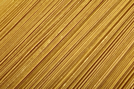 Raw bio whole grain pasta as food backgroundの写真素材