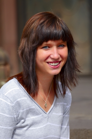Portrait of a young  woman in background a fountain, outdoor in a small city Dillingen, Saarland / Germanyの写真素材