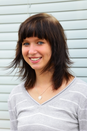 Portrait of a young  woman in background a fountain, outdoor in a small city Dillingen, Saarland / Germanyの写真素材