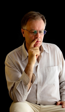 Portrait of a man on a black background, studio shot.の写真素材