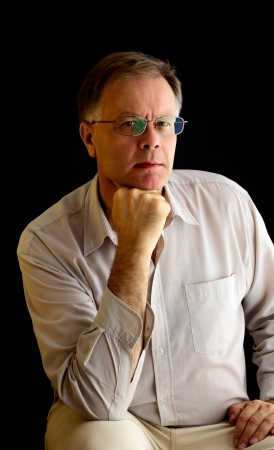 Portrait of a man on a black background, studio shot.の写真素材